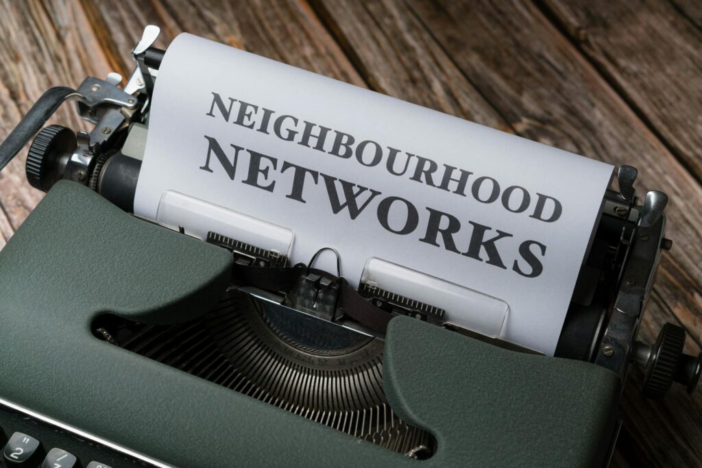 A typewriter with the words neighborhood networks on it